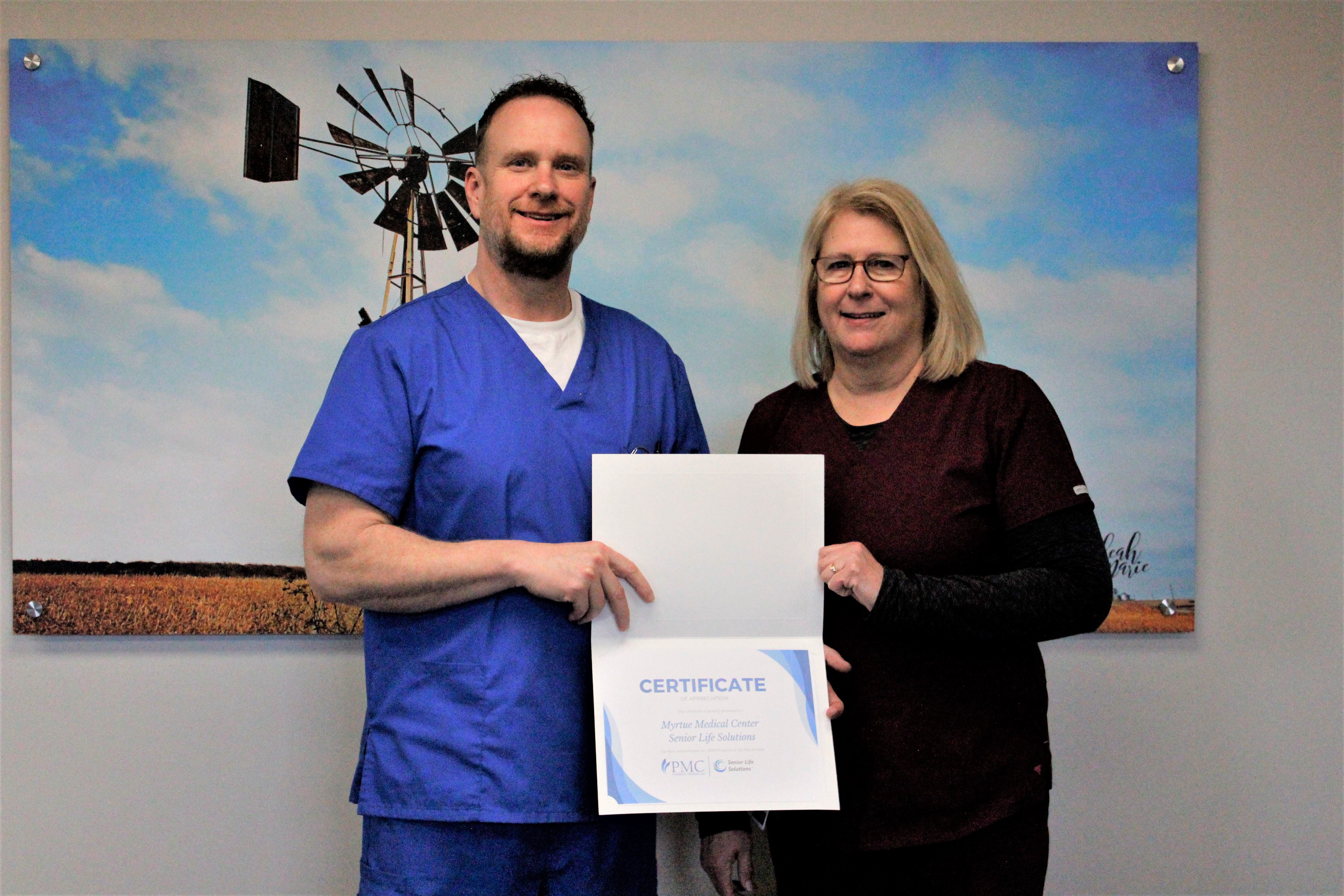 Man and woman holding a certificate