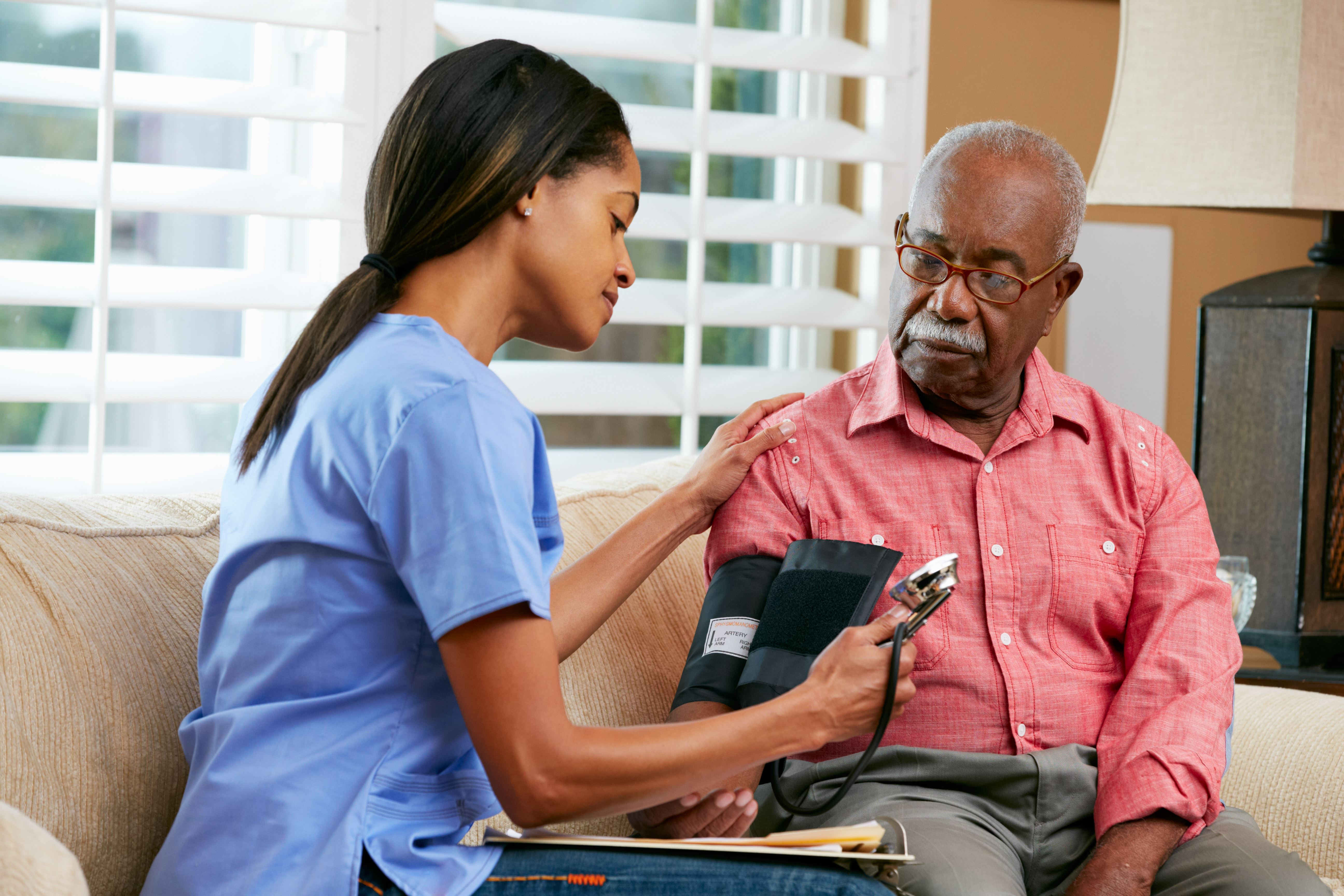 Nurse taking blood pressure to a man